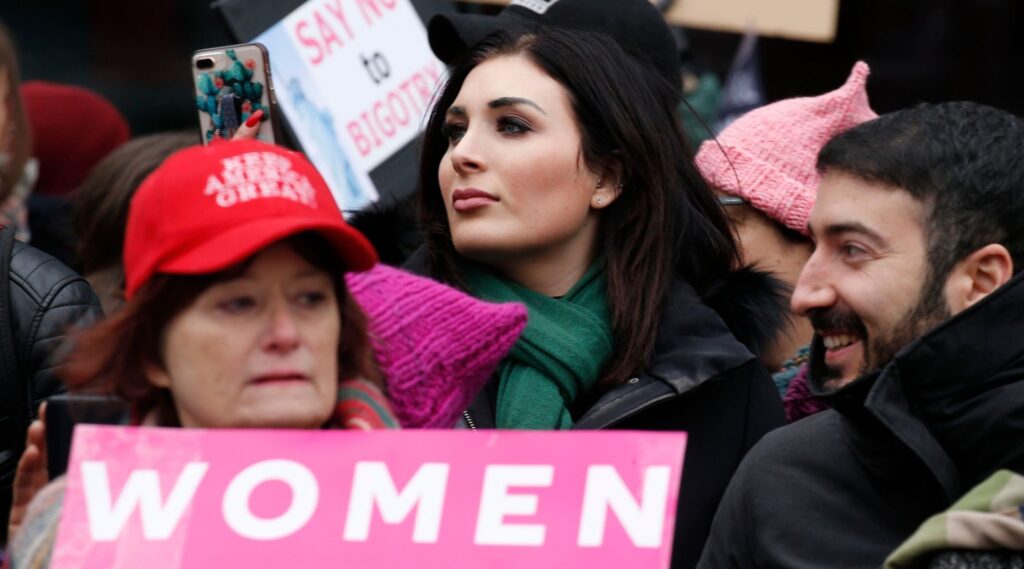 Laura Looper watches a New York Women's March from the sidelines in 2019